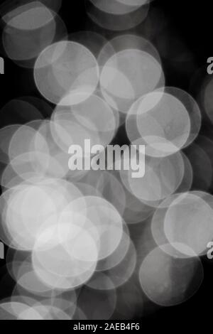 Abstract blurry light bokeh, lots of dots glowing in the nigh in black and white Stock Photo