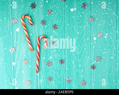 Christmas candy cane. two Christmas candy cane with frame on blue wooden background, space for text. Christmas composition, postcard Stock Photo