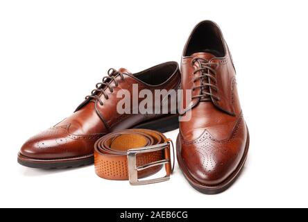 Selective focus of men's leather belt and shoe on wooden table Stock Photo