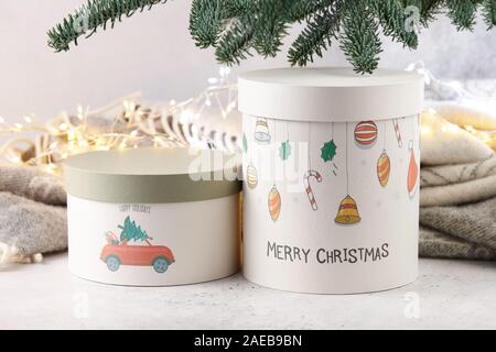 Gift boxes under Christmas tree on wool blanket and lights background, holiday concept Stock Photo