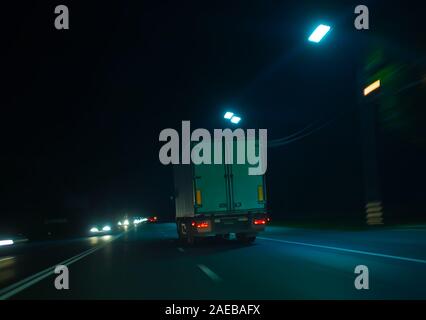 truck moves on country highway at night Stock Photo