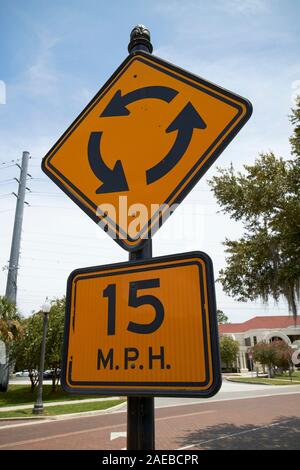 approaching roundabout right hand circle 15 mph sign in kissimmee florida usa Stock Photo