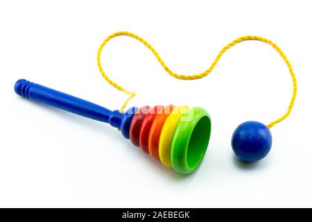 Wooden Cup-and-ball (ball in cup) toy. Children's wooden toy to catch the ball. Stock Photo