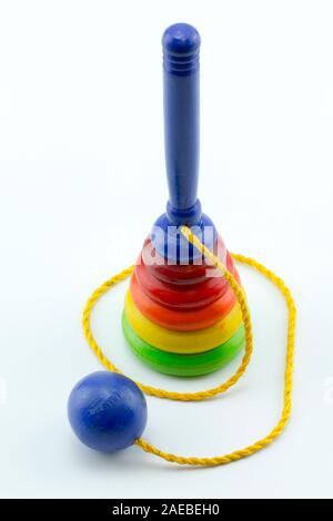 Wooden Cup-and-ball (ball in cup) toy. Children's wooden toy to catch the ball. Stock Photo