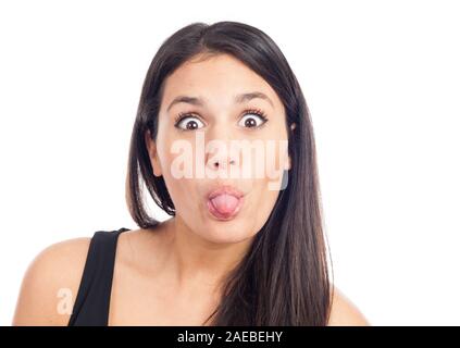 portrait of a happy young brunette woman laughing and pulling her tongue Stock Photo