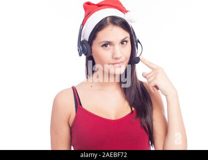 Christmas headset woman from telemarketing call center wearing red santa hat talking smiling isolated on white background. Stock Photo