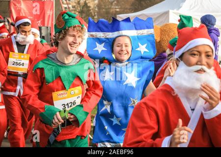 Brockwell Park, London, UK, 08th Dec 2019. Around 3000 Santa runners dressed as Father Christmas join in the annual London Santa Dash 2019. This year's 5k and 10k routes for runners of all ages leads through Brockwell Park, South London. The Santa Dash raises money to give seriously ill children at Great Ormond Street Hospital (GOSH) the chance of a better future. Stock Photo
