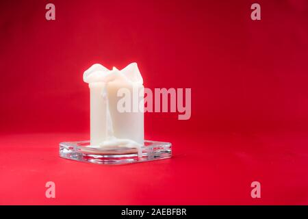 Isolated burning candle on bright vivid red background Stock Photo