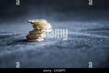 British one pound sterling coins stack isolated on dark background - money concept, economy, financial crisis, debit card, credit card, mortgage Stock Photo