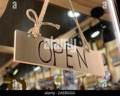Open wooden sign at the shop window of a traditional Chtistmas gift shop in Eastern European Baltic Riga Latvia Stock Photo