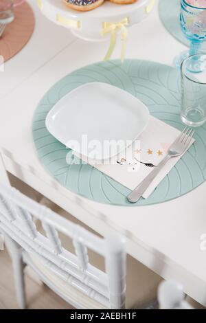 Food served on table in a white hall during a children Birthday party decoration in Eastern European Baltic Riga Latvia - Mild Biege, creme, pink Stock Photo