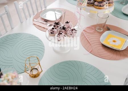 Food served on table in a white hall during a children Birthday party decoration in Eastern European Baltic Riga Latvia - Mild Biege, creme, pink Stock Photo