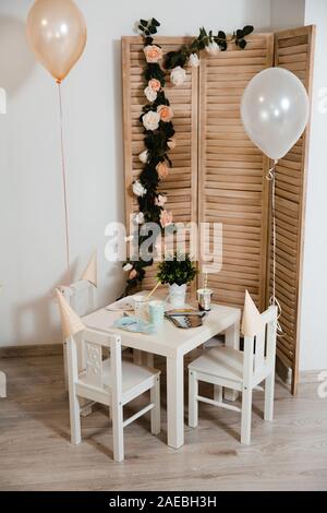 Food served on table in a white hall during a children Birthday party decoration in Eastern European Baltic Riga Latvia - Mild Biege, creme, pink Stock Photo