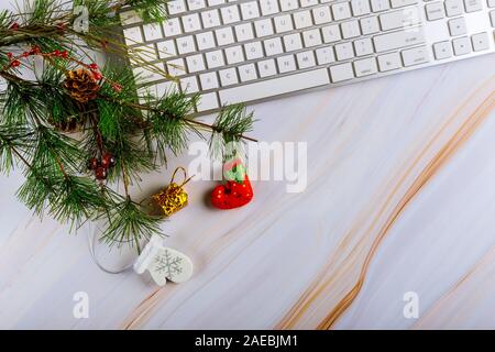 Christmas composition with computer keyboard with ornaments on the Christmas tree Stock Photo