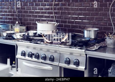 Typical kitchen of a restaurant in operation, pan on gas burner, toned image Stock Photo