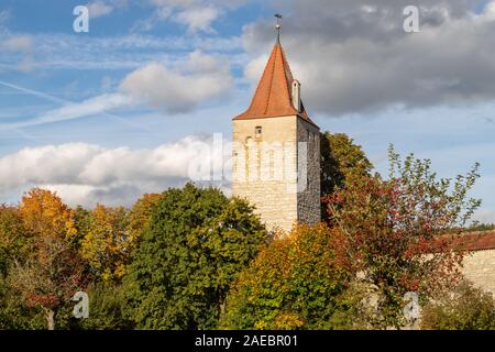 Autumn landscape with multicolored trees and city wall with tower in Berching, Bavaria on a sunny day