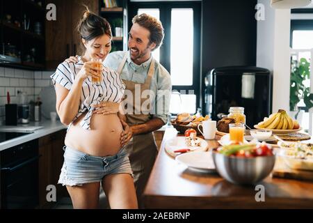 Beautiful happy lovely young couple expecting baby Stock Photo