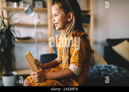 Little smart girl playing with abacus at home