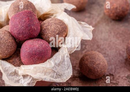 Close Up of Homemade Raw Vegan Cacao Energy Balls in Bowl with Craft Paper Stock Photo