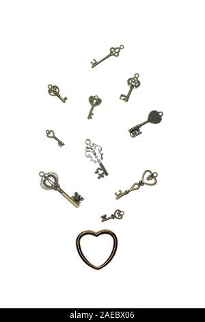 Vintage skeleton keys with metall heart on white background. Stock Photo