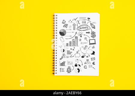 White paper page with doodles and business strategies on a yellow background Stock Photo