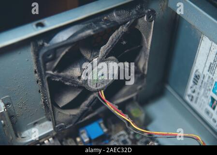 Dust on computer pc processor cooler with mainboard and computer case fragment. Selective focus. close up, macro. concept of cleaning parts of compute Stock Photo