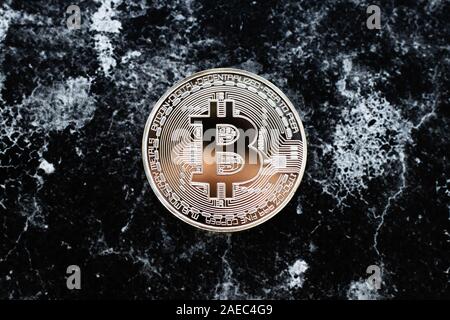 One bitcoin on dark background. E-commerce concept. Cryptocurrency Stock Photo