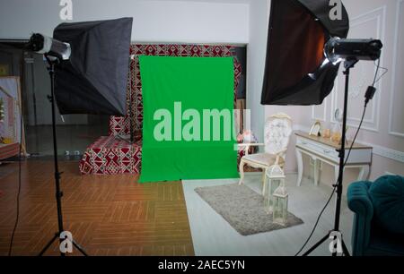 The chroma key. Real empty green screen Chroma key film photo studio with lighting studio equipment . green screen chroma key background on commercial Stock Photo