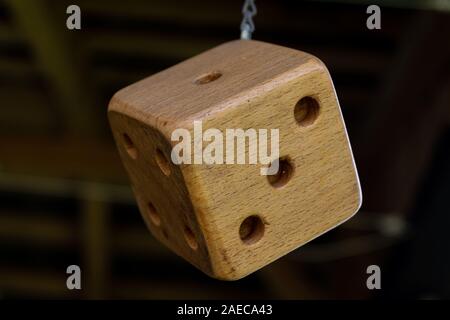 A hanging six side wooden dice Stock Photo