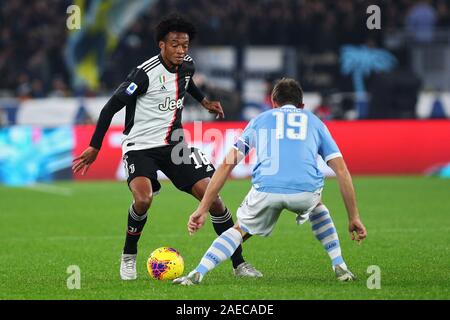 Juan Cuadrado (L) of Juventus and Senad Lulic (R) of Lazio in action during the Italian championship Serie A football match between SS Lazio and Juventus on December 7, 2019 at Stadio Olimpico in Rome, Italy - Photo Federico Proietti/ESPA-Images Stock Photo