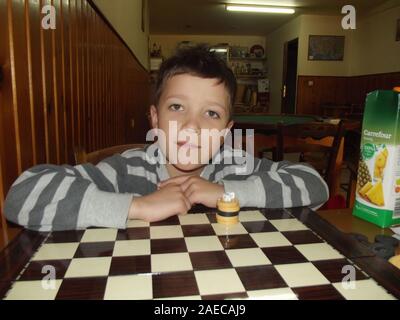 Boy in a traditional greek kafenion Crete, Greece. Stock Photo