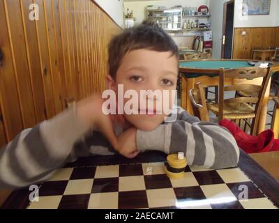 Boy in a traditional greek kafenion Crete, Greece. Stock Photo