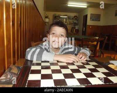 Boy in a traditional greek kafenion Crete, Greece. Stock Photo