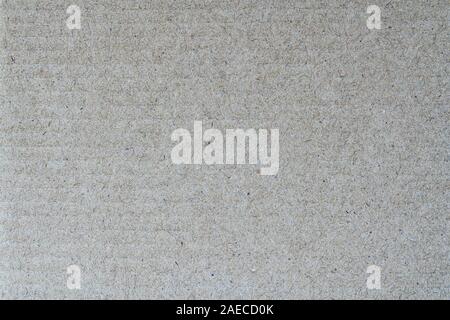 Light brown abstract background from sheet of recycled cardboard. Close-up detail view texture recycled eco-friendly material pattern background Stock Photo