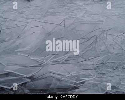 Clear ice washed up on the river shore like shards of glass. Background pattern close up Stock Photo