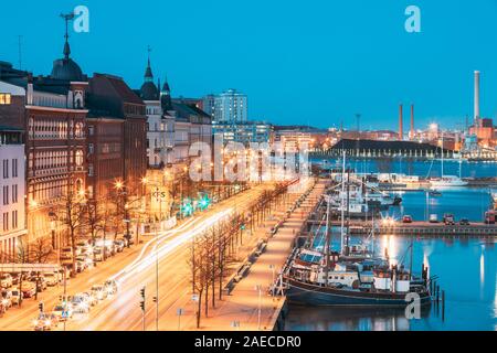 Helsinki, Finland - December 10, 2016: View Of Pohjoisranta Street And Ships, Boats And Yachts Moored Near Pier In Evening Night Illuminations. Stock Photo