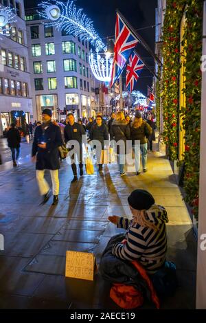 Luxury shops on New Bond Street, beggar, Christmas time in London, Stock Photo