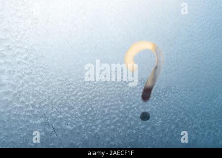 Question mark hand written on a frozen window, place for text, copyspace. Stock Photo