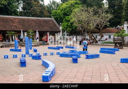 Preparation for event with plastic stools in courtyard, Temple of Literature, Hanoi, Vietnam Stock Photo