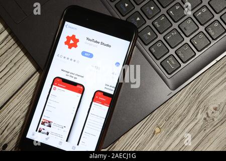 Los Angeles, California, USA - 3 December 2019: YouTube Studio App Logo on phone screen with laptop flat lay, Illustrative Editorial. Stock Photo