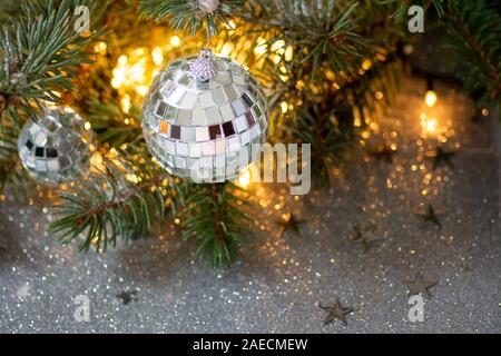 Shiny Christmas tree with ornaments and festive background Stock Photo