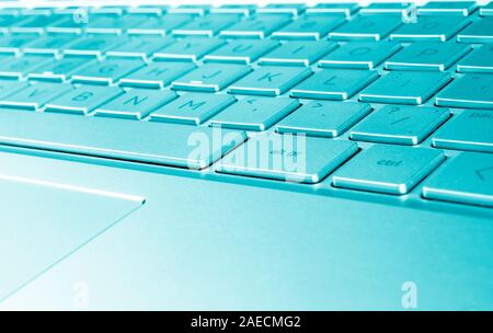 Closeup of a modern silver laptop computer keyboard. Laptop keyboard. Detail of the new and ergonomic computer keyboard. Stock Photo