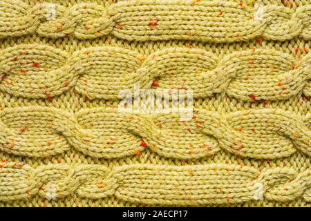 Texture of Wool Knit Color of Mustard Fabric Interspersed with Red Orange Yarn. Sweater Background Close-Up View Stock Photo