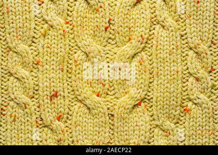 Texture of Wool Knit Color of Mustard Fabric Interspersed with Red Orange Yarn. Sweater Background Close-Up View Stock Photo