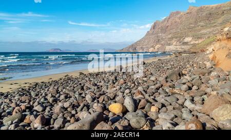 Beautiful view of the pebble and sand beach of Famara, Lanzarote, Canary Islands, Spain Stock Photo