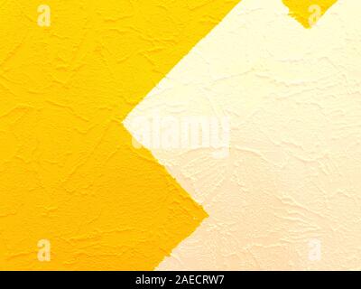 The texture of the wall is painted in two bright colors. The wall is painted in white and yellow. Stock Photo