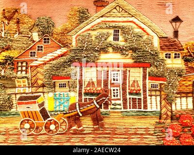 Beautiful embroidery with a countryside scene. A horse cart is passing by at home. Stock Photo