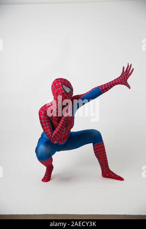 December 1, 2019. Israel, tel Aviv. Spiderman posing on a white background, the animator dressed as a spider in the pose concept of entertainment Stock Photo