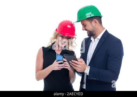 Successful young engineers using mobile communication devices, isolated on white Stock Photo
