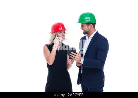 Co-operative young engineers with mobile communication devices, isolated on white Stock Photo